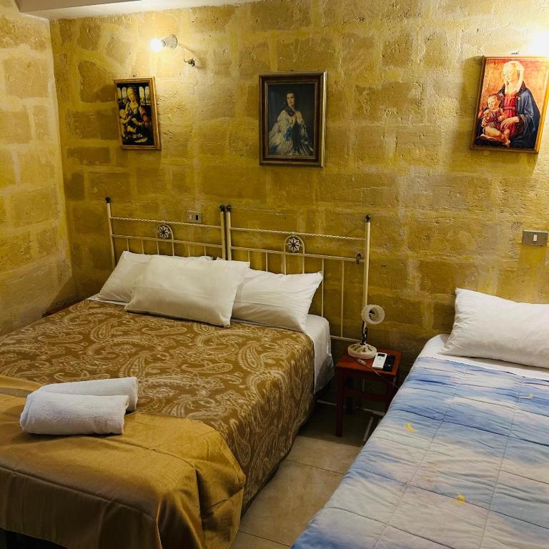 a bedroom with two beds in a room at Santa Cesarea Sassi in Matera