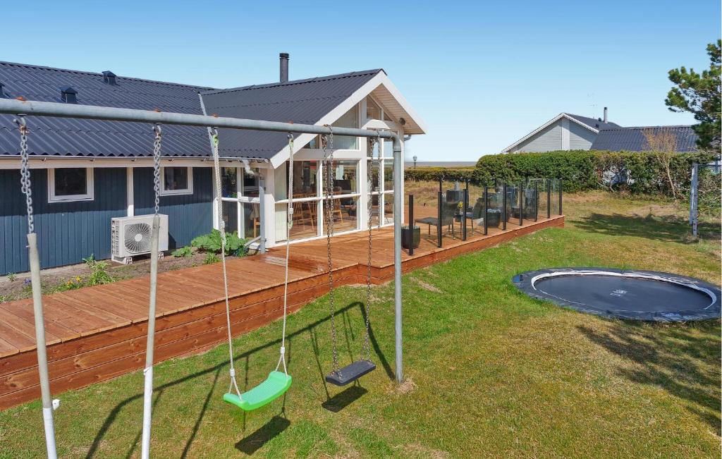 a backyard with a swing set and a trampoline at St Croix in Hadsund