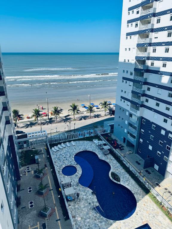 a view of the beach from a building at Apto frente o mar com 3 piscinas Wi-Fi gratuito aceito pet in Mongaguá