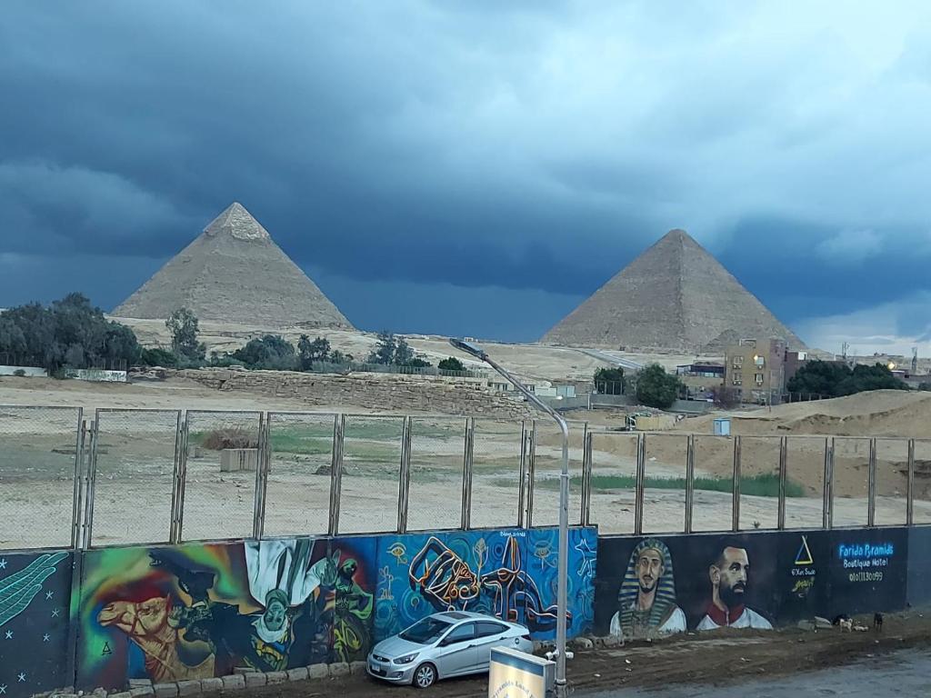 a car parked in front of the pyramids at Sneferu hotel pyramids View in Cairo