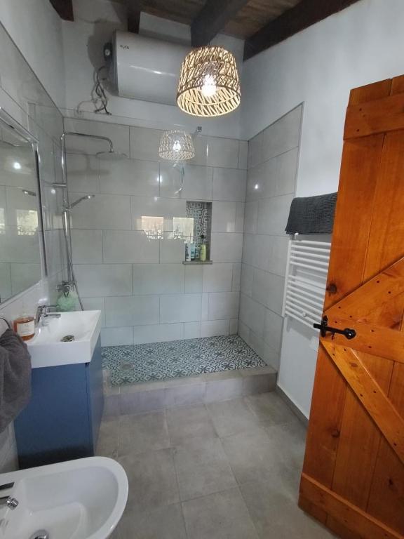 a bathroom with a sink and a shower at The Retreat in Las Encebras