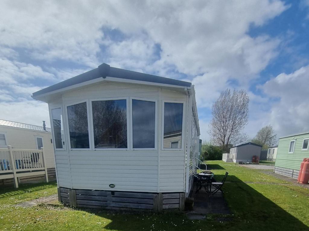 a tiny house sitting in a yard at 3 bed 2 bath Static on parkdean morecambe in Morecambe