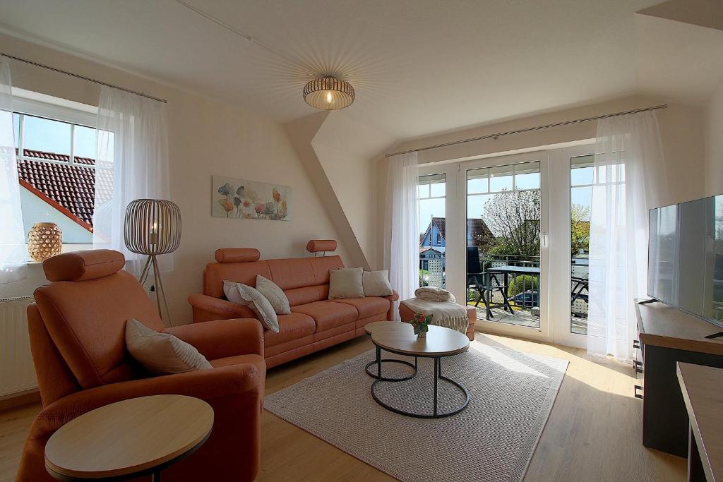 a living room with a couch and a tv at PM09 KüstenReich in Wremen