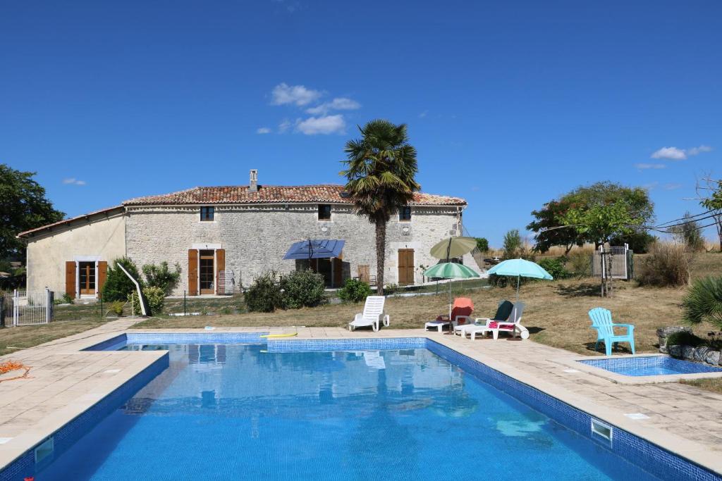 a villa with a swimming pool in front of a house at Au Charme Charentais Gite geel in Blanzaguet-Saint-Cybard-le-Peyrat