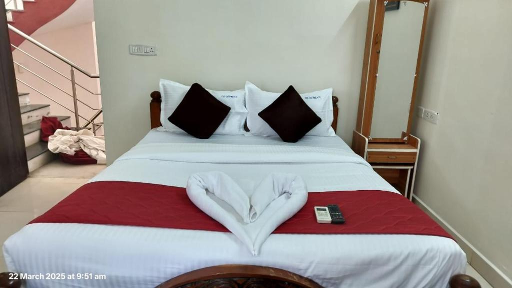 a bedroom with a bed with a heart shaped pillow at Grand home villas in Jāmb