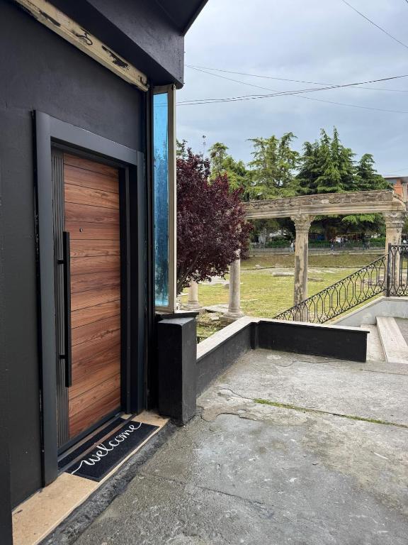 a wooden door on the side of a house at Forum View Apartments in Durrës