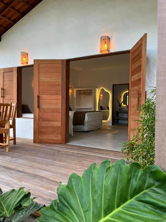 a bedroom with a bed in a room with at Casa Ninho in Atins