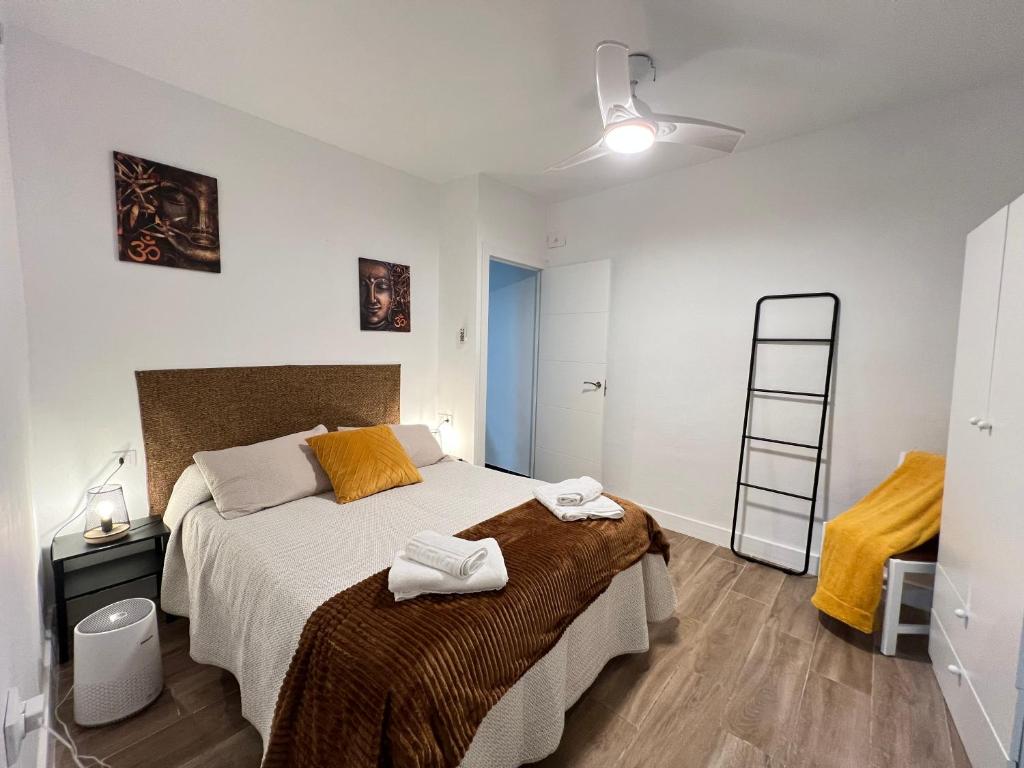 a bedroom with a large bed and a ladder at Todimer Costa Peñon in Torrenueva