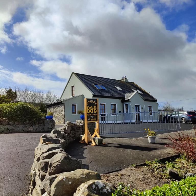 a house with a sign in front of it at Boherbui B&B in Doolin