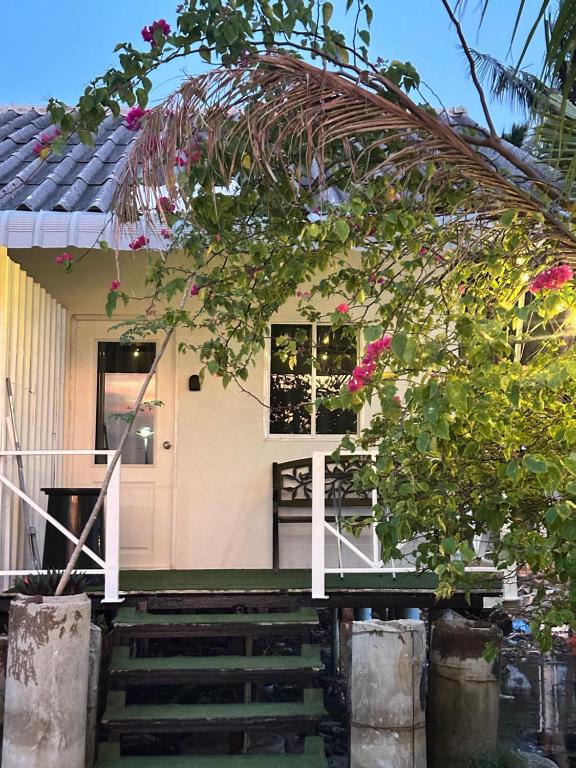 a house with stairs leading to the front door at Summer Sunshine in Songkhla