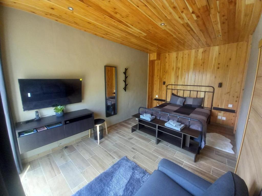 a bedroom with a bed and a tv in a room at CdR Casa do Rei in Lajes das Flores