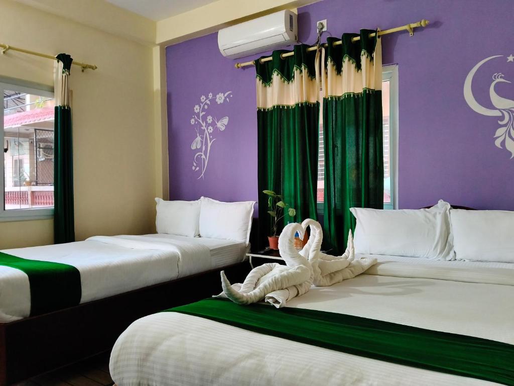 a hotel room with two beds with a stuffed animal on them at Tiger wildlife camp in Sauraha