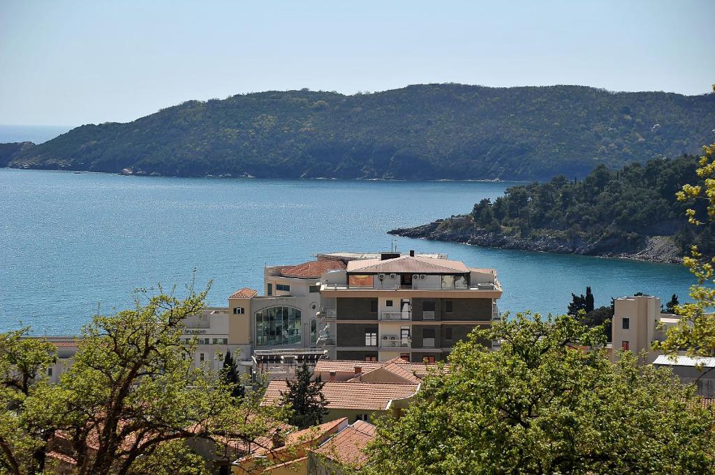 a large building next to a large body of water at SeaWolf Apartment in Bečići