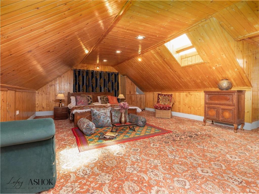a living room with a couch and a table at Luxury Ashok Cottage in Srinagar