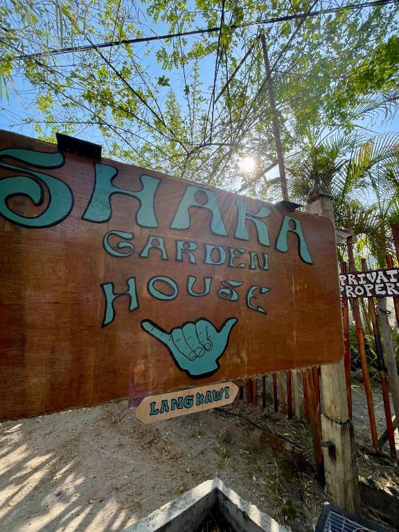 a sign for a garden house with graffiti on it at Surf house langkawi in Pulau Tepur