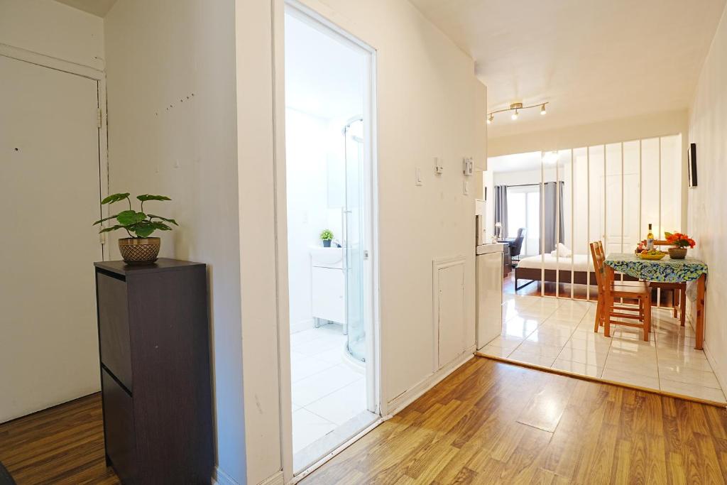 a living room with a large glass door and a dining room at Comfort Residence in Montreal