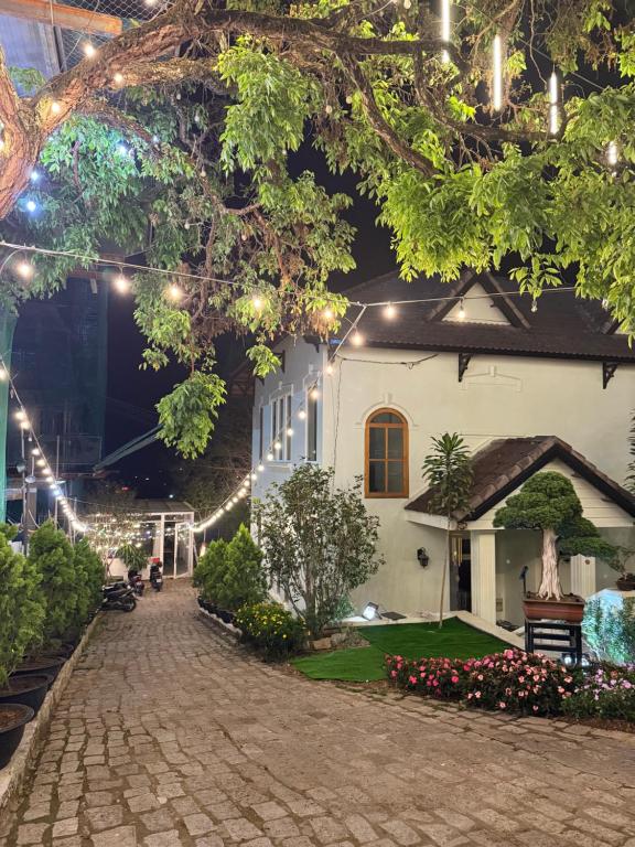 a courtyard of a house at night with lights at Bếp Thông home in Xuan An