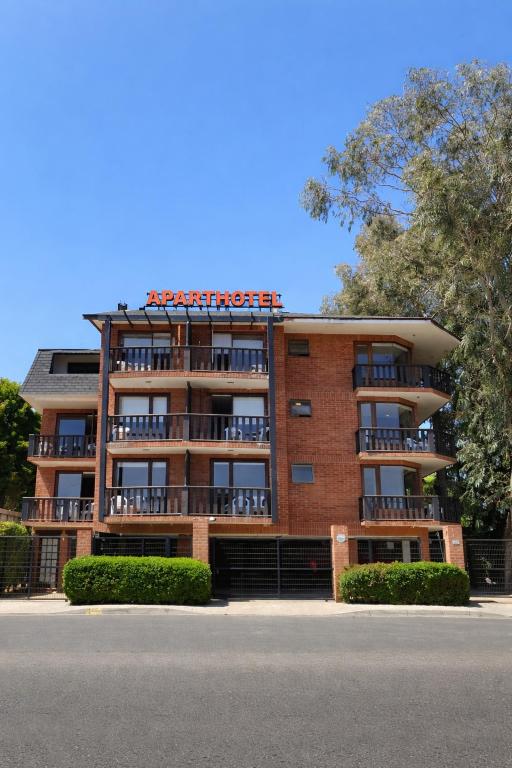 a brick building with a sign on top of it at Linda Vista Apart Hotel in Concón