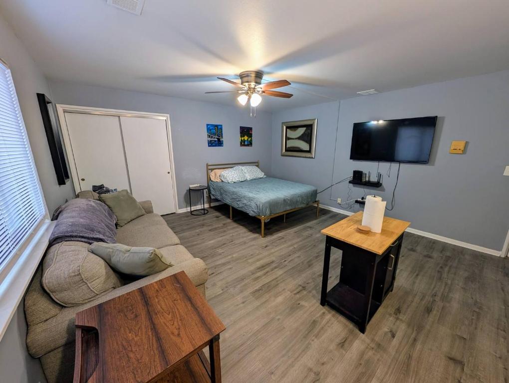 a living room with a couch and a bed at Spacious Studio near Brady St in Milwaukee