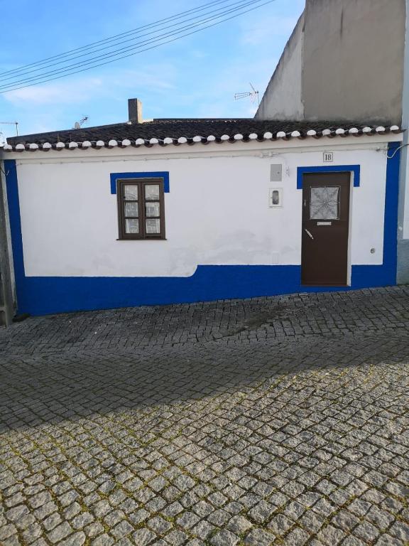 a white and blue building with a door at Ferreira do Alentejo Terrace Rustic Villa in Beja