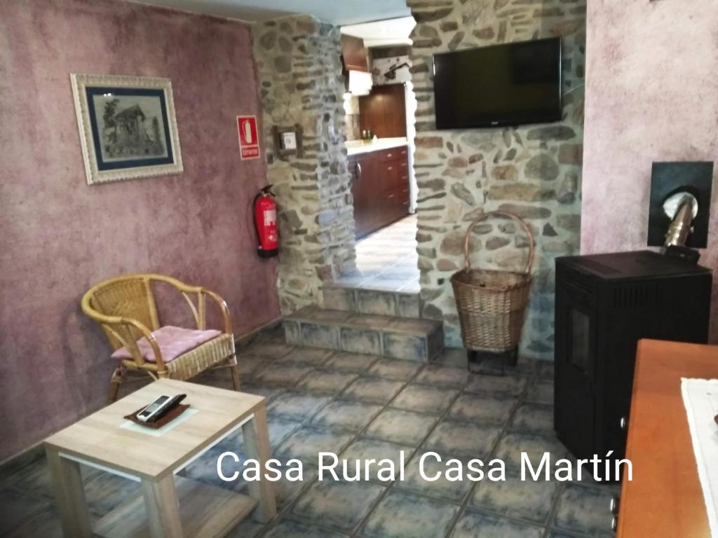 a living room with a table and a tv at Casa Rural Casa Martin in Cueva de Ágreda