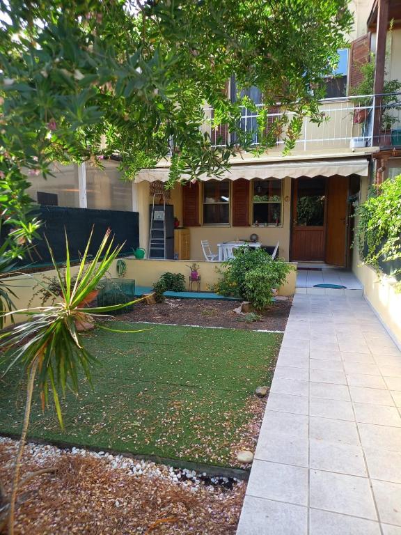 a house with a lawn in front of it at Sole in Quartu Sant'Elena