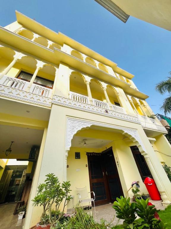 a large yellow building with a balcony on it at Chitawa Haveli A Luxury Heritage Hotel in Jaipur