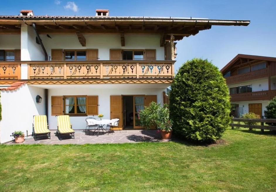 a house with a table and chairs in the yard at Haus Lara - Fewo 3 in Wallgau