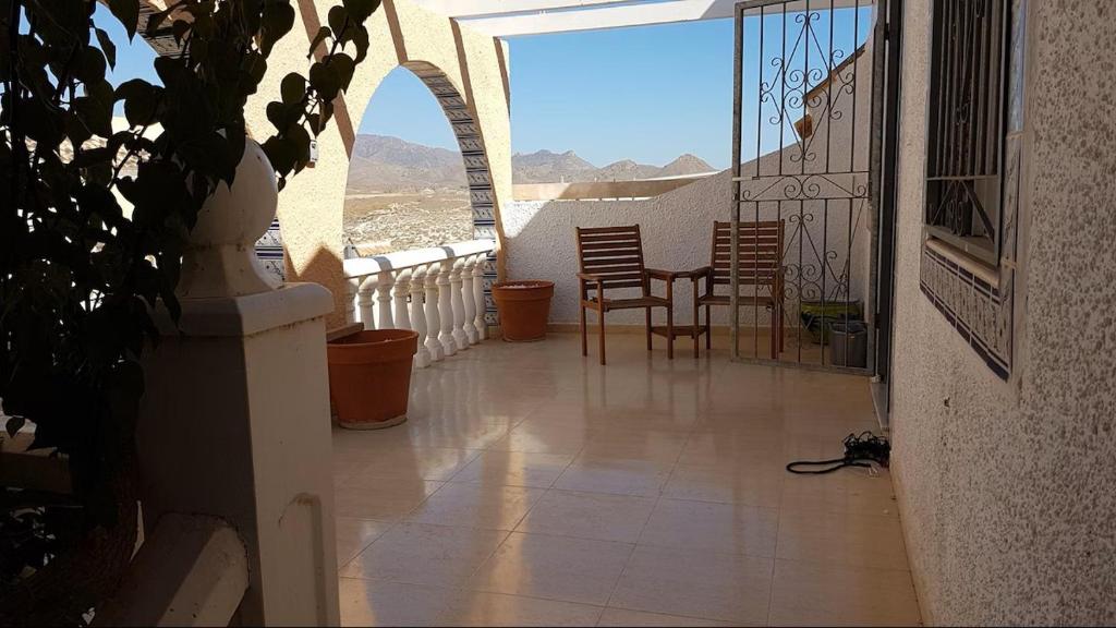 a balcony with chairs and a table with a view at Camposol House in Mazarrón