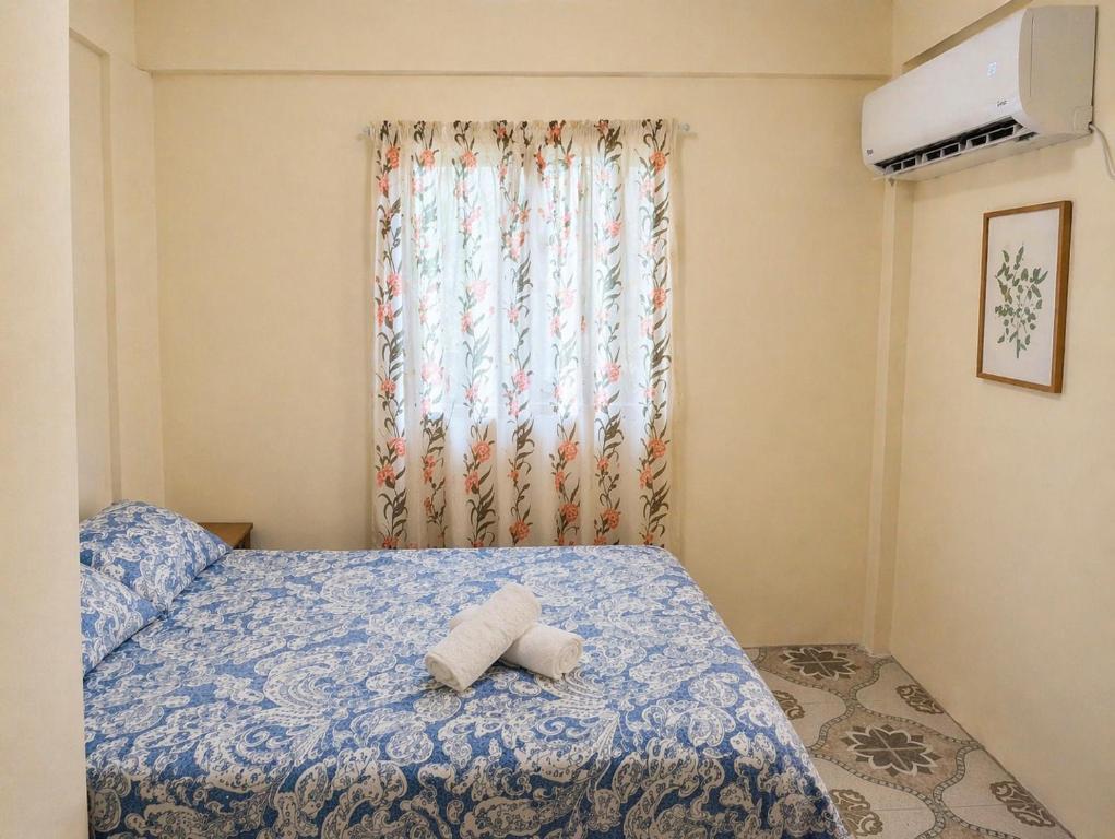 a bedroom with a bed with a towel on it at BtC Apartments St Paul's in Saint Paulʼs