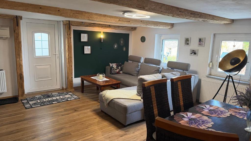 a living room with a couch and a table at Wünsch Dir was in Großweitzschen