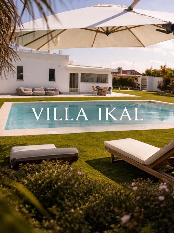 a swimming pool in front of a villa kigil at Villa Ikal in Modugno