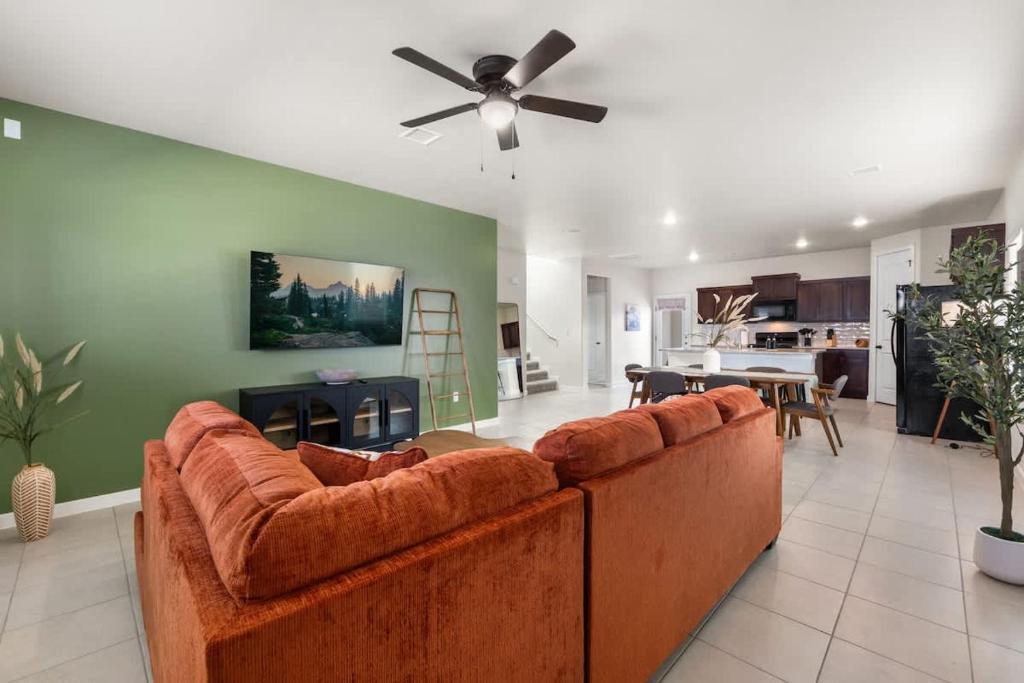 a large living room with a couch and a ceiling fan at Stylish 4BR Escape Open Layout TVs in Every Room in El Paso