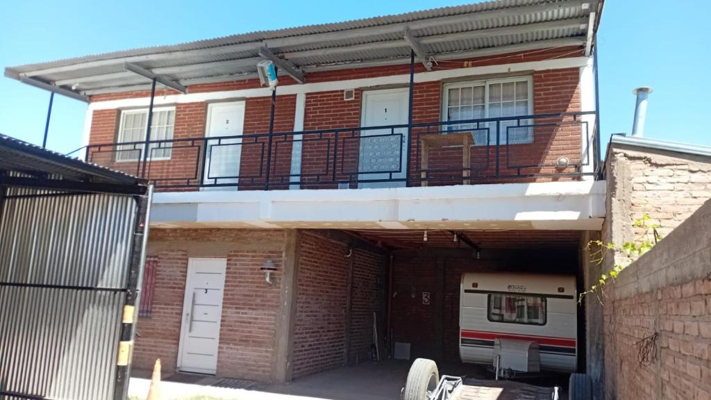 an apartment building with a balcony and a garage at Dptos Edu in Malargüe