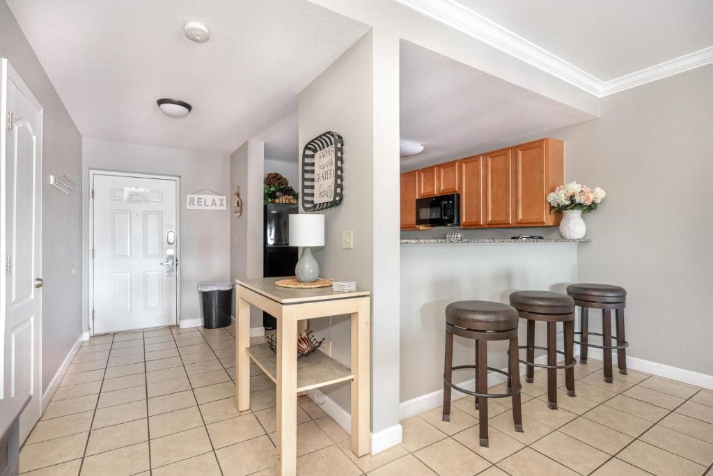 a kitchen with a table and stools in a room at Mountain View Condo 1306 in Pigeon Forge