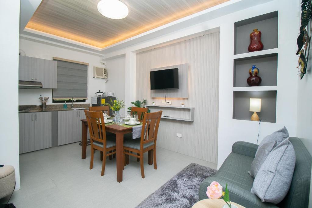 a living room and kitchen with a table and chairs at 206 Executive Granvia Suites in Cagayan de Oro