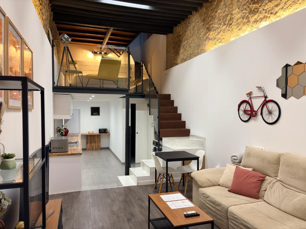 a living room with a couch and a staircase at LOFT La Palma in Almería