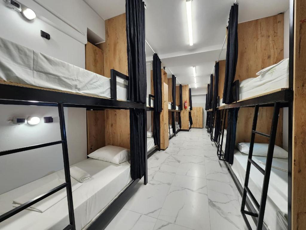 a row of bunk beds in a hallway at The HANGOUT Hostel in Sarandë