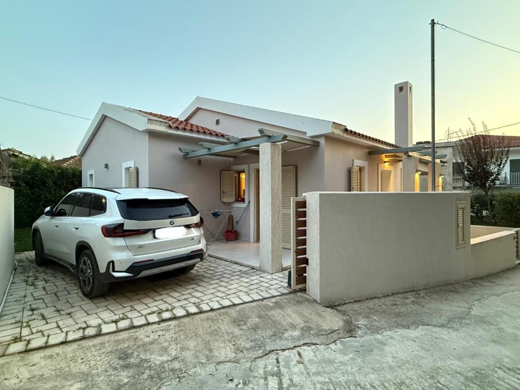 a white car parked in front of a house at Makis & Lena's Home in Svoronata