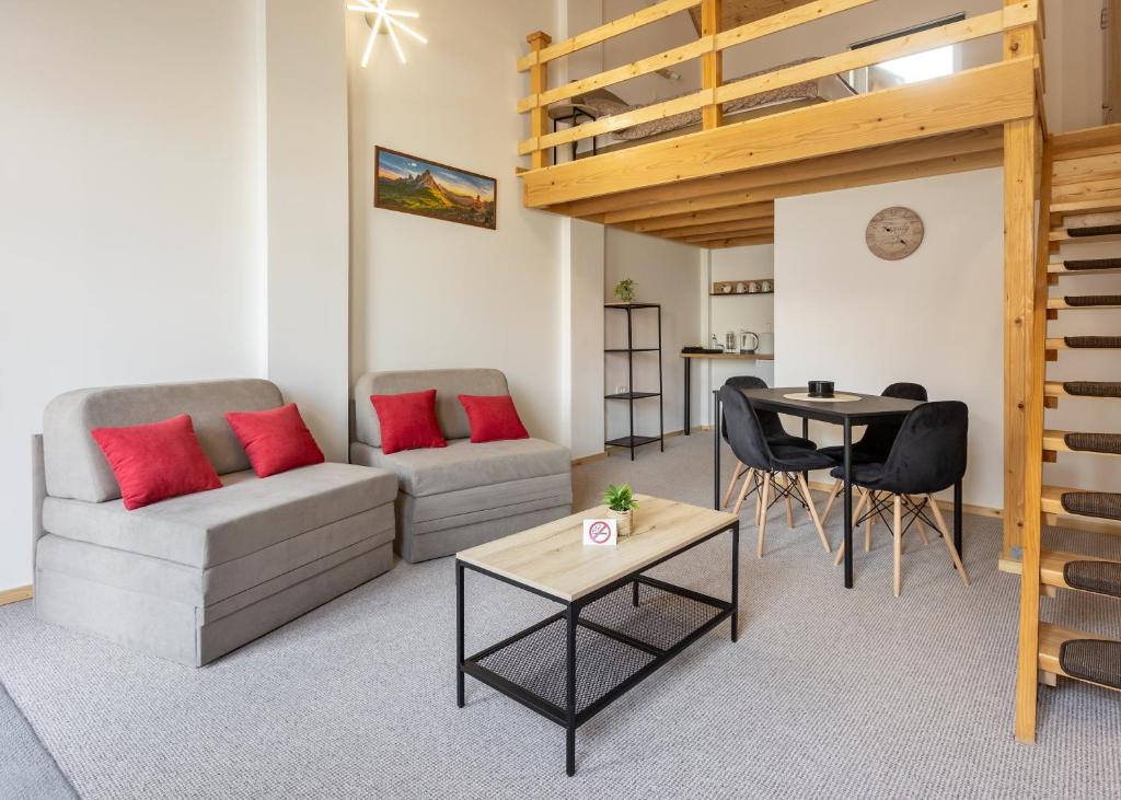 a living room with a couch and a table at KING rooms in Bečej