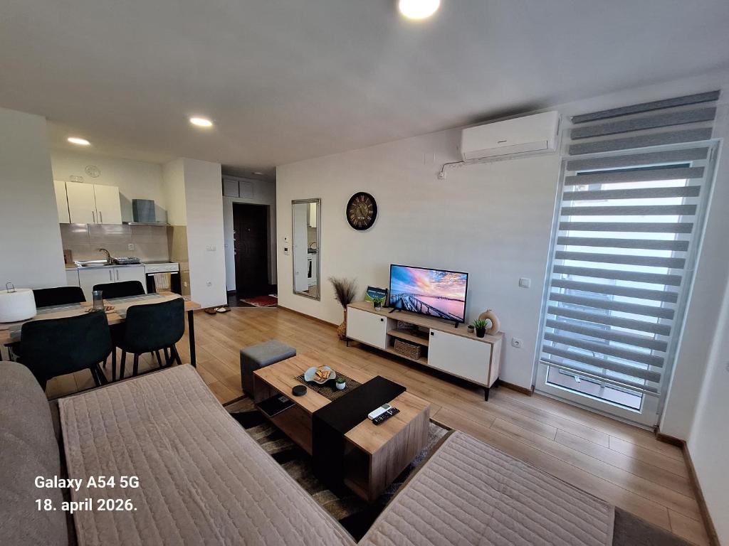 a living room with a couch and a tv at Stan na dan UNO Modriča in Modriča