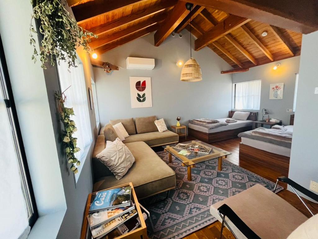 a living room with a couch and a table at AGASA residence in Fujieda