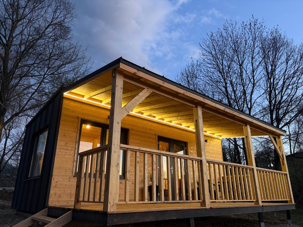 a tiny house with a large deck at The Little House in Sohodol