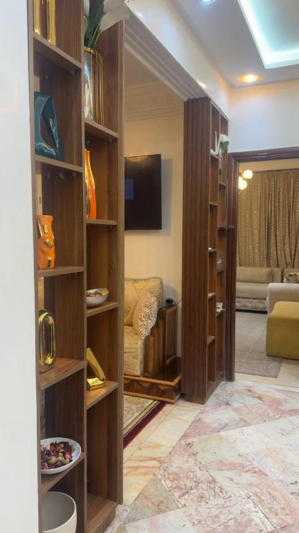 a living room with wooden shelves in a room at Charme appartement in Mohammedia