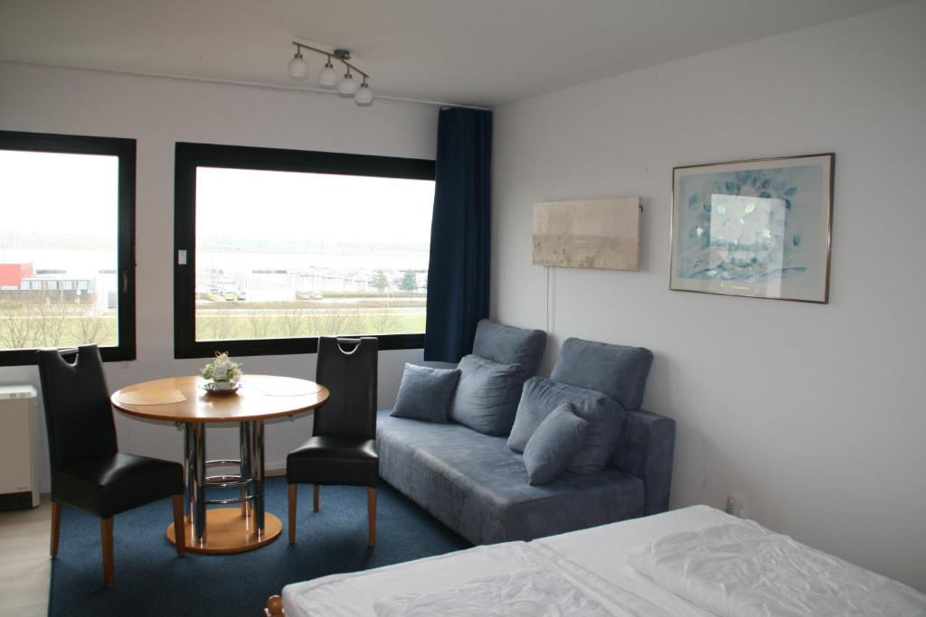 a living room with a couch and a table at FW Knütel Nr 57 in Burgtiefe auf Fehmarn 