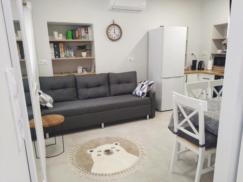 a living room with a couch and a kitchen at KIS Home in Loúros