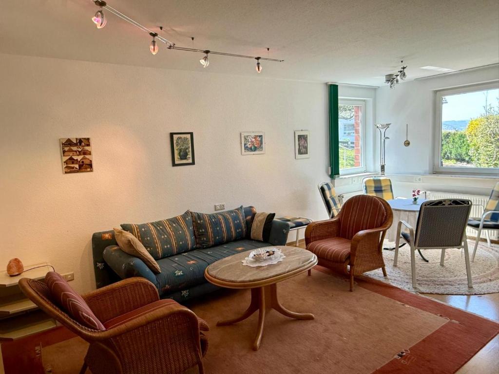 a living room with a couch and chairs and a table at Gemütliche Ferienwohnung mit Sauna & Terrasse in Monzingen