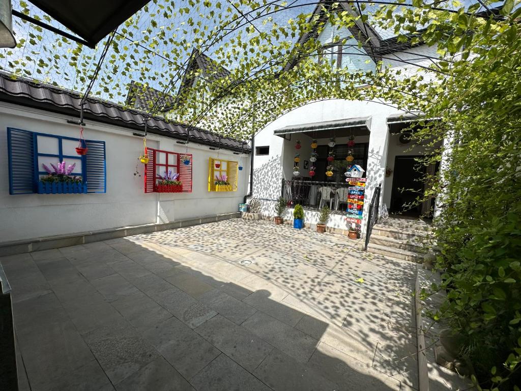 a white building with a glass ceiling and a room at Three Home in Quba