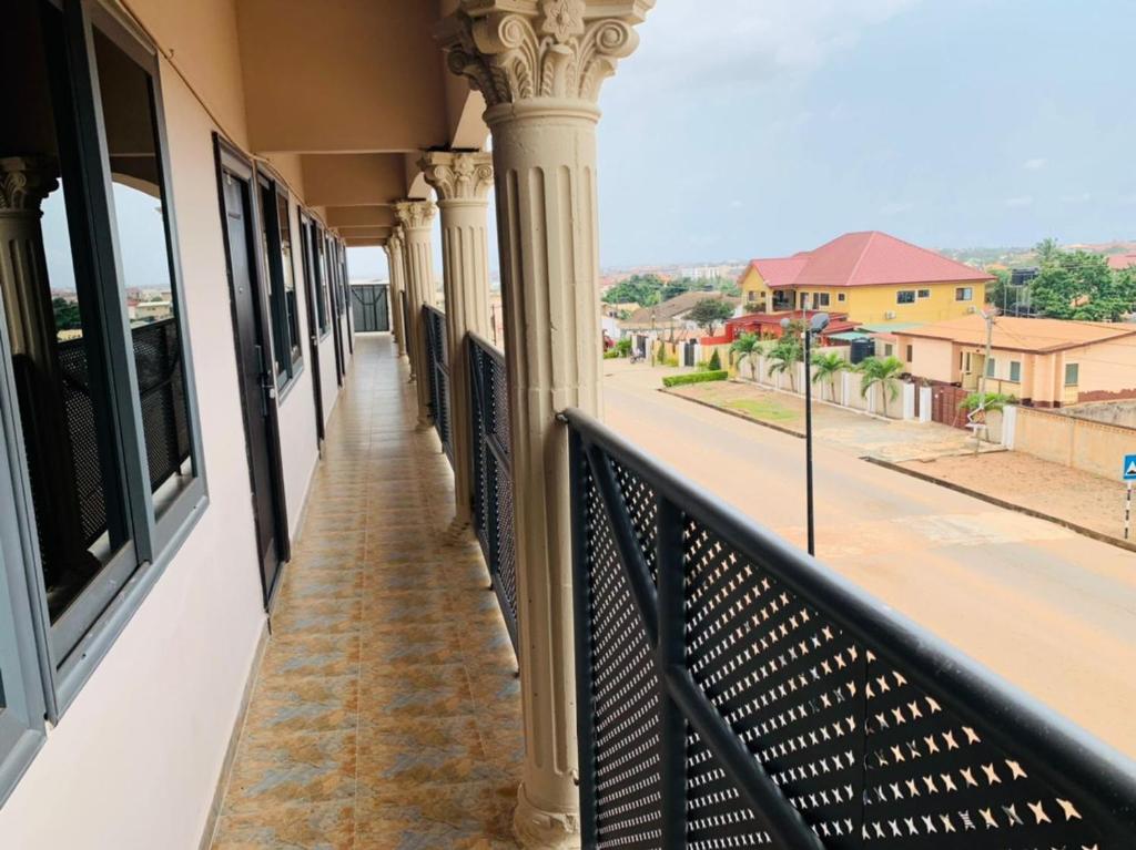 a balcony of a building with a view of a street at Water House Lodge in Apenkwa