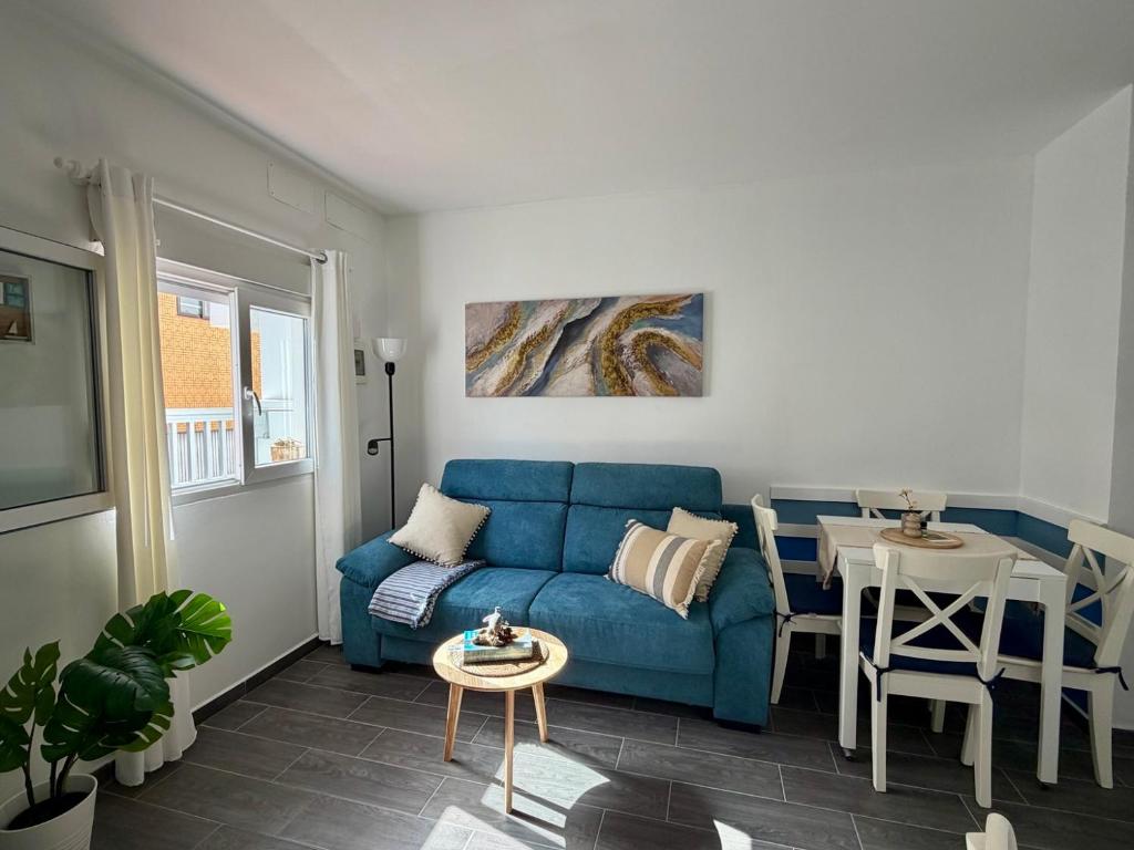 a living room with a blue couch and a table at Apartamento Maravía La Restinga in La Restinga